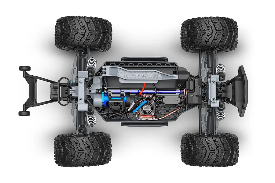 Top-down view of a Traxxas Stampede 4X4 RC monster truck chassis showing the brushless motor, electronic speed controller, and drivetrain components.