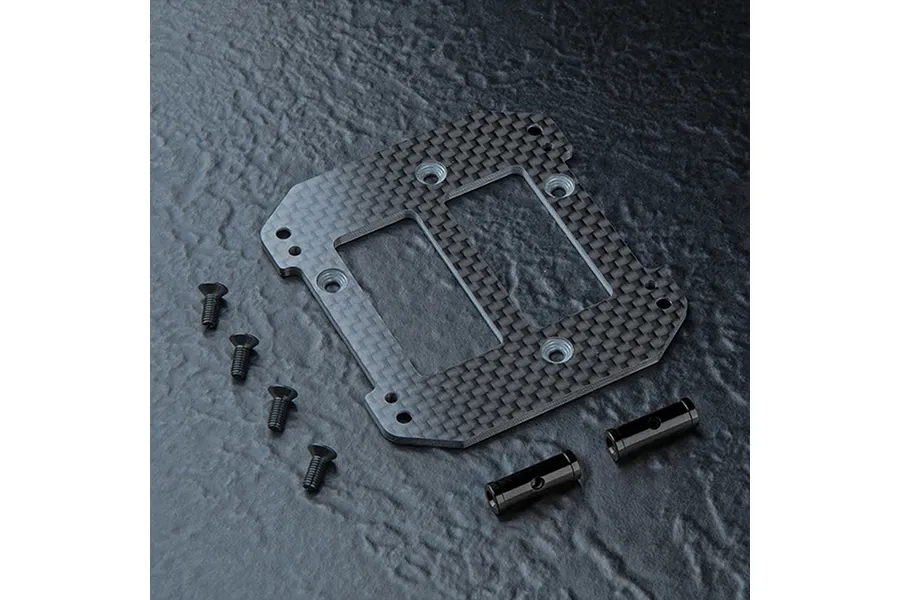 MST carbon fibre battery mount plate with four screws and two cylindrical metal posts on a dark textured background.