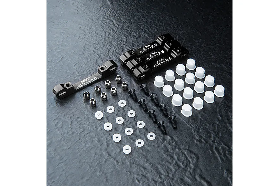 MST aluminium suspension arm mount set in black, including four metal mounts, screws, ball studs, and plastic spacers on a dark textured surface.