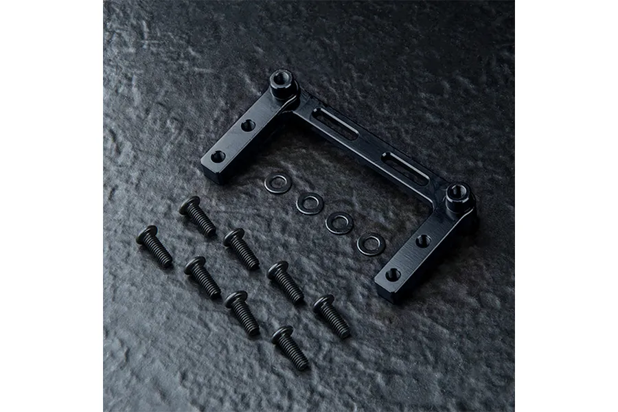 A black aluminium RC servo mount with mounting hardware including screws and washers on a dark textured surface.