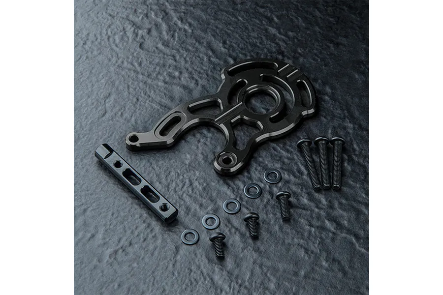 MST black aluminium motor mount set including a main mount plate, a support bar, and various screws and washers on a dark textured surface.