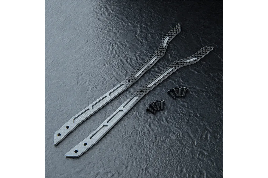 Two carbon fiber upper deck chassis plates for an RC car, accompanied by eight small black screws, arranged on a dark textured surface.