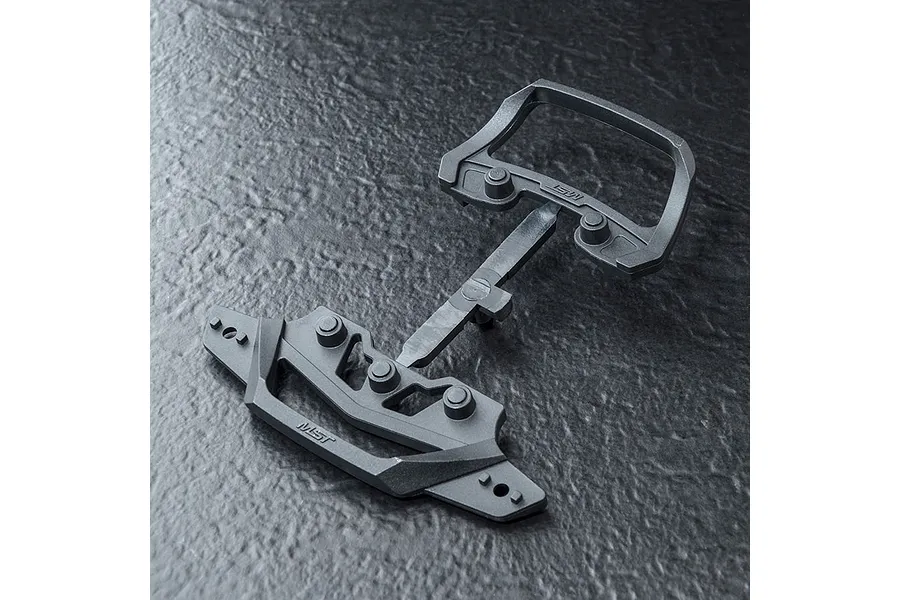 MST lightweight front bumper mount set for RC cars, featuring black plastic parts on a sprue against a dark textured background.