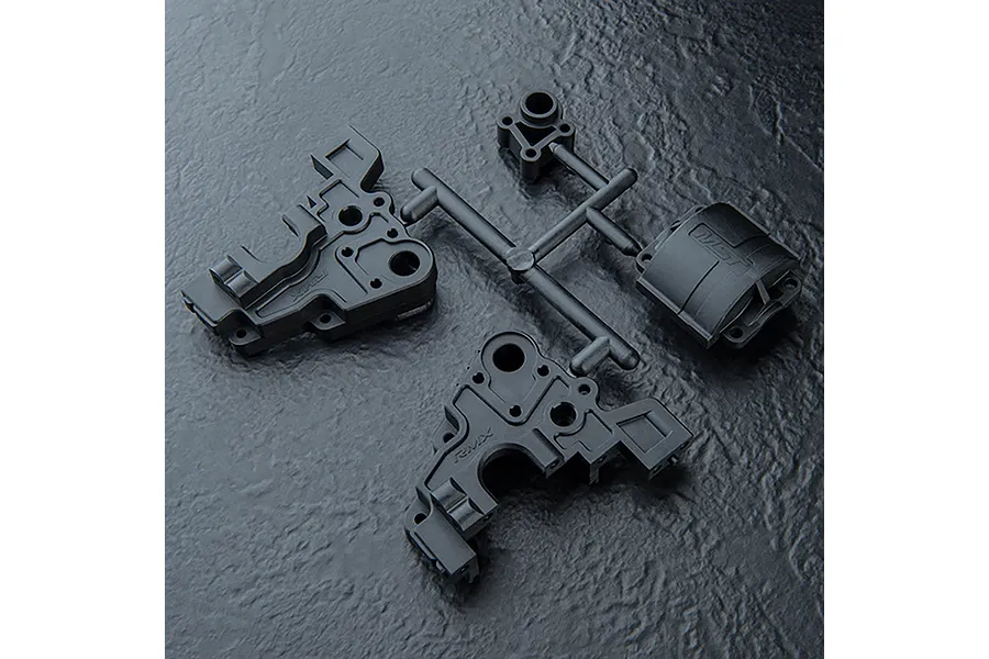 MST black plastic rear gearbox case parts for an RC car, still attached to the plastic sprue tree.