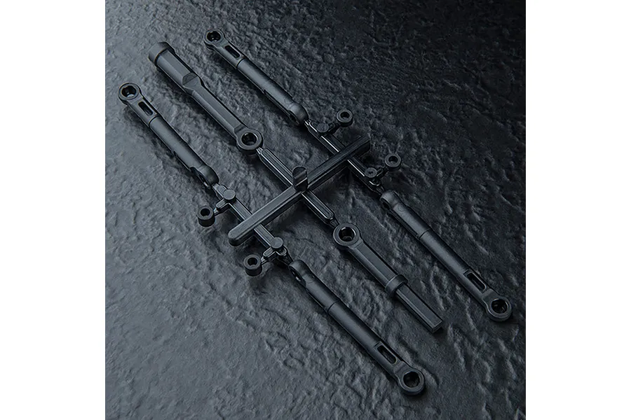 A set of black plastic RC turnbuckles and suspension links still attached to their original injection molding sprue tree.