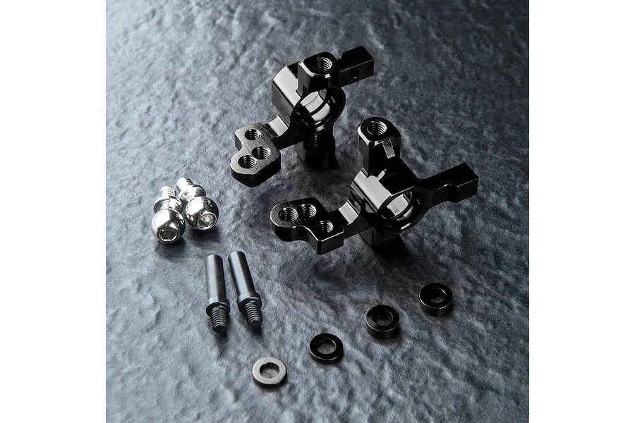 A set of black MST Aluminium ATK V3 steering hubs with included hardware, including ball studs, screws, and spacers on a dark textured surface.