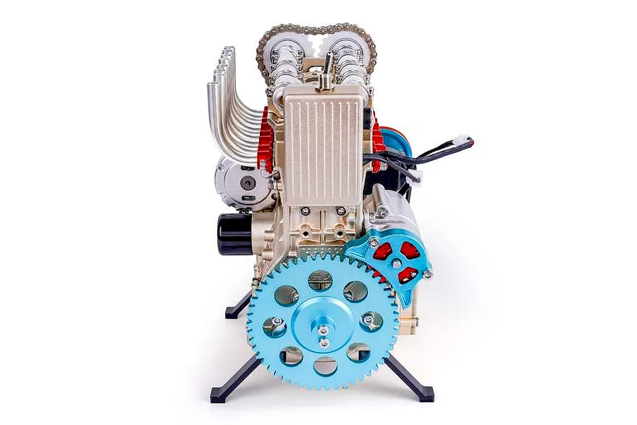 A front-facing view of the Teching DM113 four-cylinder engine model kit, featuring metallic gold, blue, and red components on a white background.