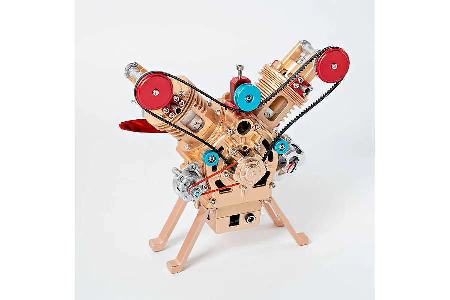 A detailed metal model of a V-twin engine with gold, red, and blue components, standing on a white background.