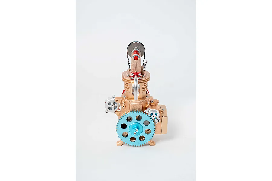 Front view of a Teching DM117 single cylinder engine model kit featuring a large light blue gear and gold-toned metal components.