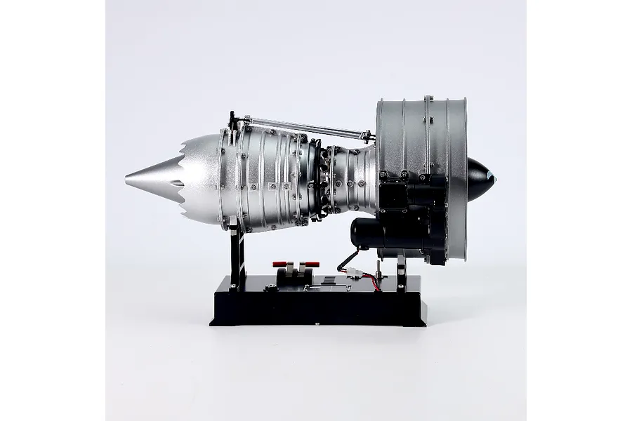 Side view of a Teching DM121 civil turbofan engine model kit mounted on a black display base against a white background.
