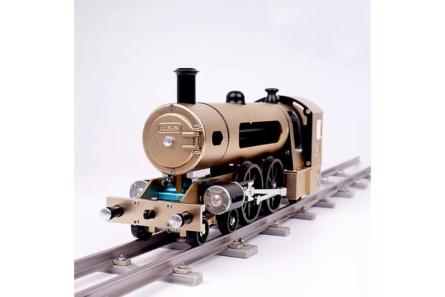A Teching DM221 steam train metal model kit sitting on a short section of model railway track against a plain white background.