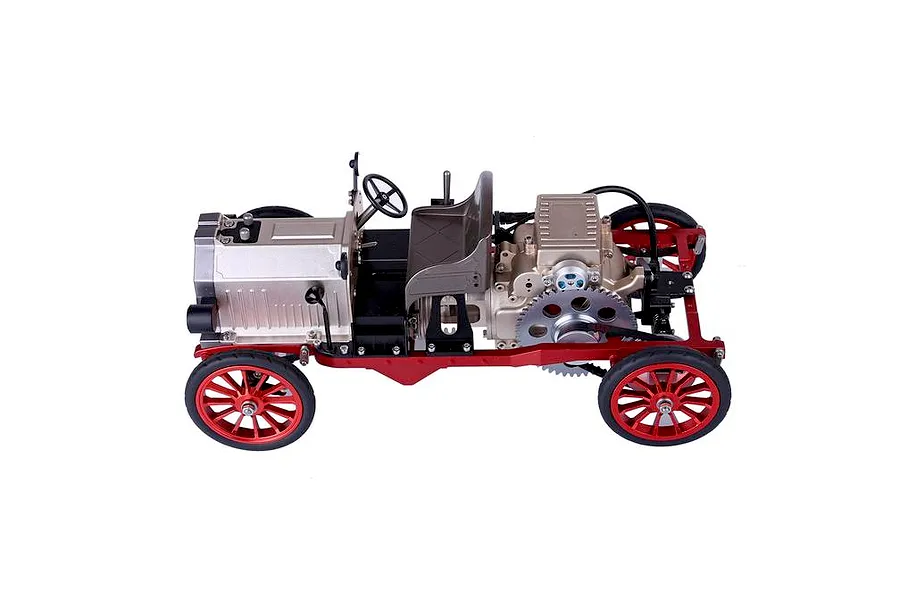 A side view of the Teching DM227 classic car metal model kit, featuring a red chassis, silver engine components, and spoked wheels on a white background.