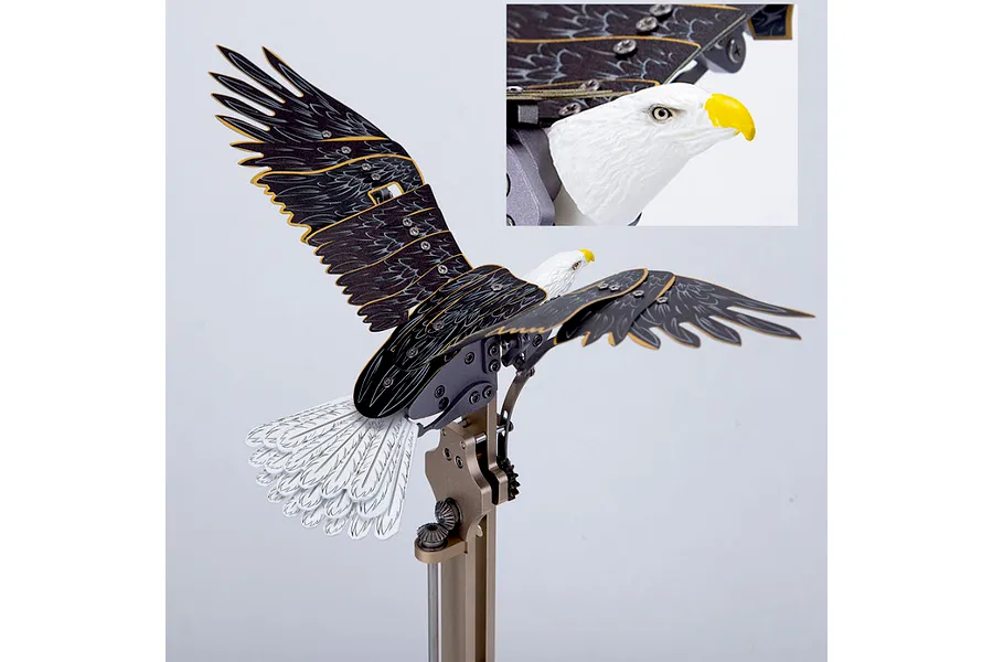 A Teching DM337 Eagle metal model kit showing a mechanical eagle mounted on a stand with an inset close-up of the eagle head.