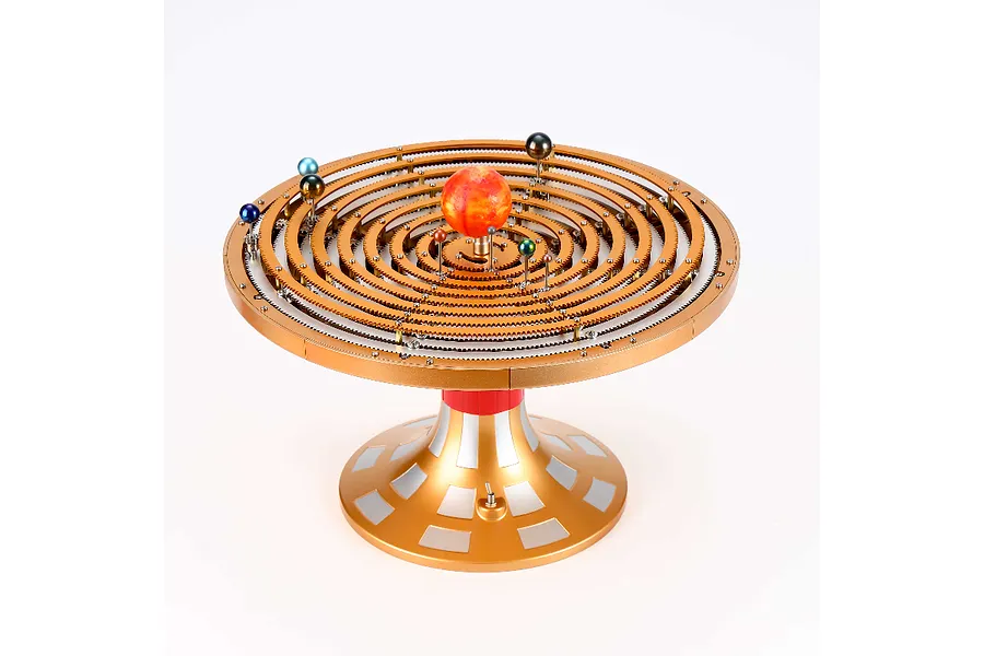 A Teching DM405 solar system model kit featuring a central sun and orbiting planets on concentric gold-coloured metal gear rings on a pedestal base.