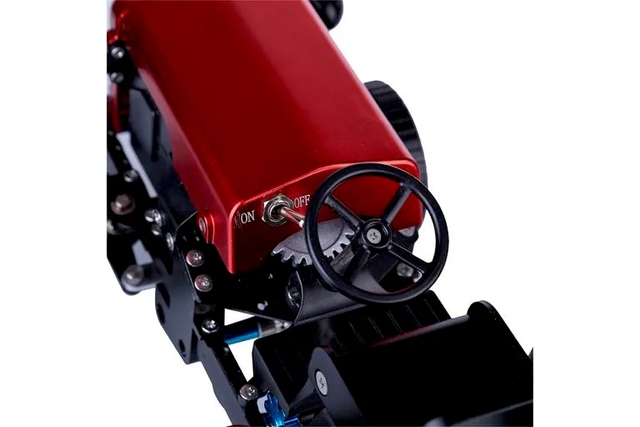 Close-up of the Teching DM616 metal tractor model kit, showing the red hood, steering wheel, and power toggle switch.