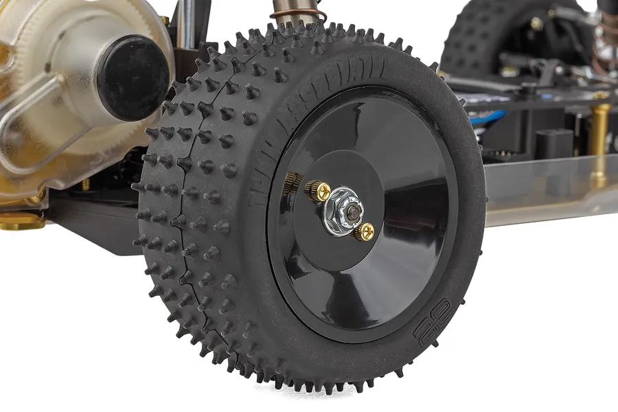 Close-up of the rear wheel and gearbox assembly of a Team Associated RC10 1/10 scale RC buggy on a white background.