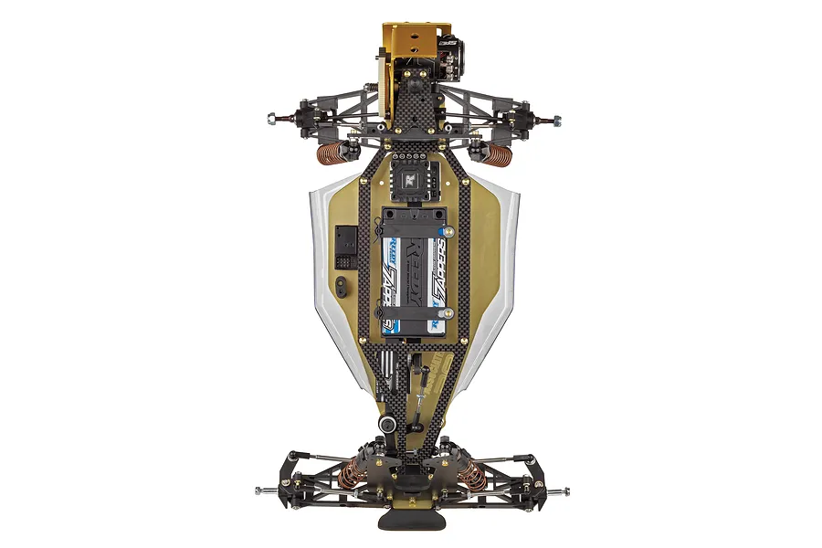 Top-down view of a Team Associated RC10 1991 Stealth Las Vegas Edition RC buggy chassis featuring a gold anodized aluminum tub and carbon fiber components.