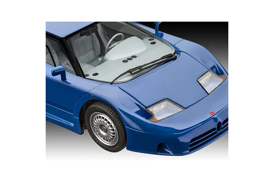 A high-angle close-up shot of a blue Bugatti EB 110 scale model car, showing the front hood, windshield, and interior details.