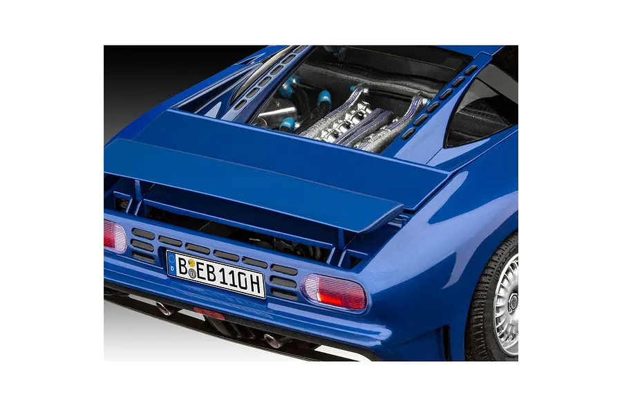 A close-up view of the rear section of a blue Bugatti EB 110 model car, showing the engine bay, rear spoiler, taillights, and German license plate.
