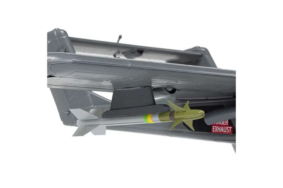 Close-up of the underside of an E-Flite Micro OV-10 Bronco RC plane wing showing a mounted scale missile and a danger exhaust warning label.