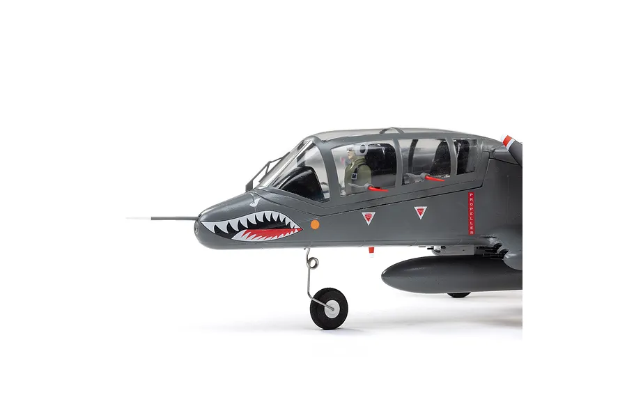 Close-up side view of the E-Flite Micro OV-10 Bronco RC plane cockpit and nose, featuring shark mouth nose art and a pilot figure.