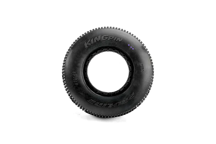 A single Pro-Line King Pin 1/5 scale off-road RC tyre viewed from the side, featuring molded branding and three purple dots indicating compound.