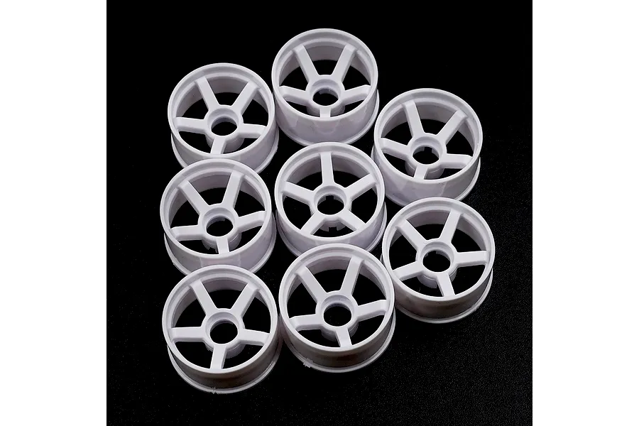 A set of eight white plastic RC car rims with a five-spoke design arranged on a black background.