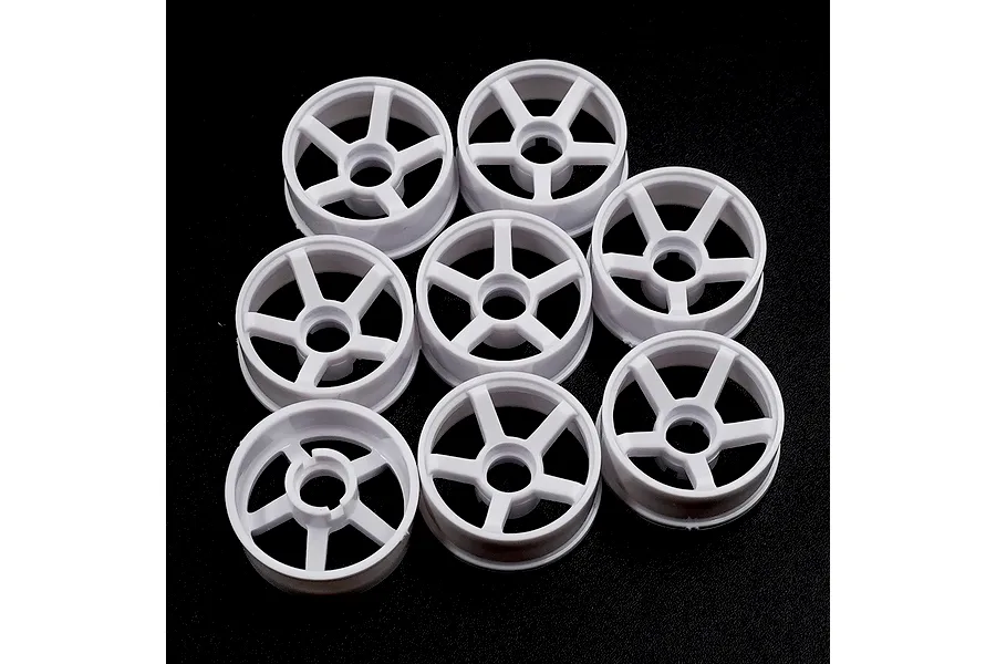 A set of eight white plastic RC car rims with a five-spoke design arranged on a black background.