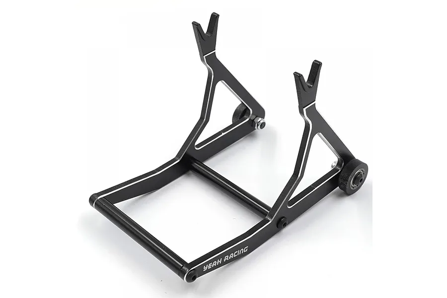 A black aluminium RC car maintenance stand by Yeah Racing, featuring a V-shaped cradle design and small wheels on a white background.