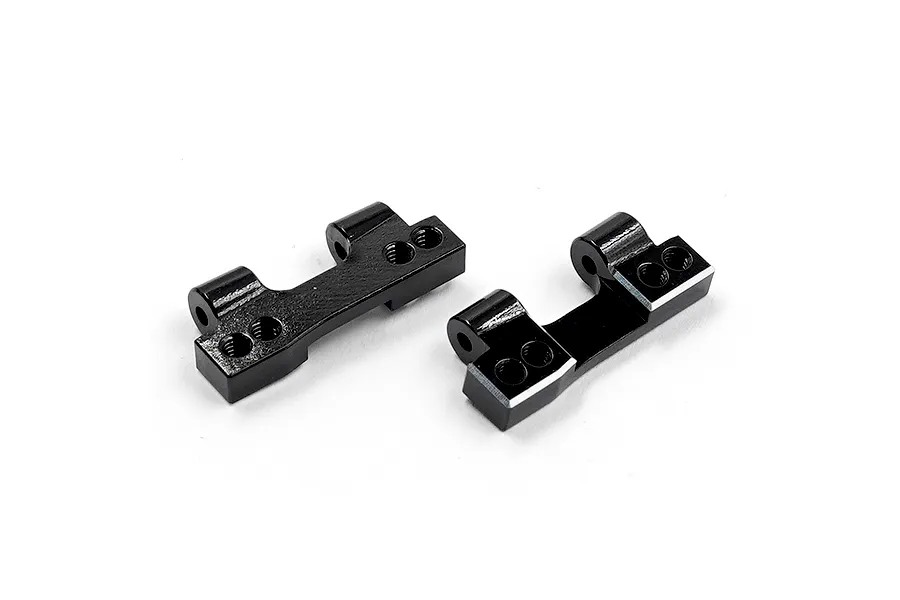 Two black anodized aluminium rear lower arm mounts for RC cars, shown from a high-angle perspective on a white background.