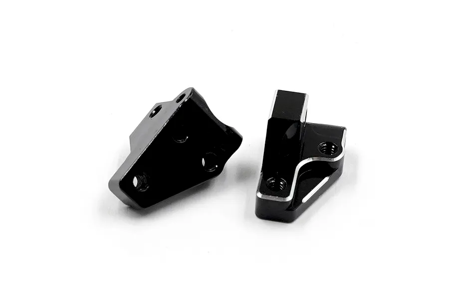 Two black anodized aluminium front lower arm mounts for RC cars, featuring machined edges and threaded mounting holes.