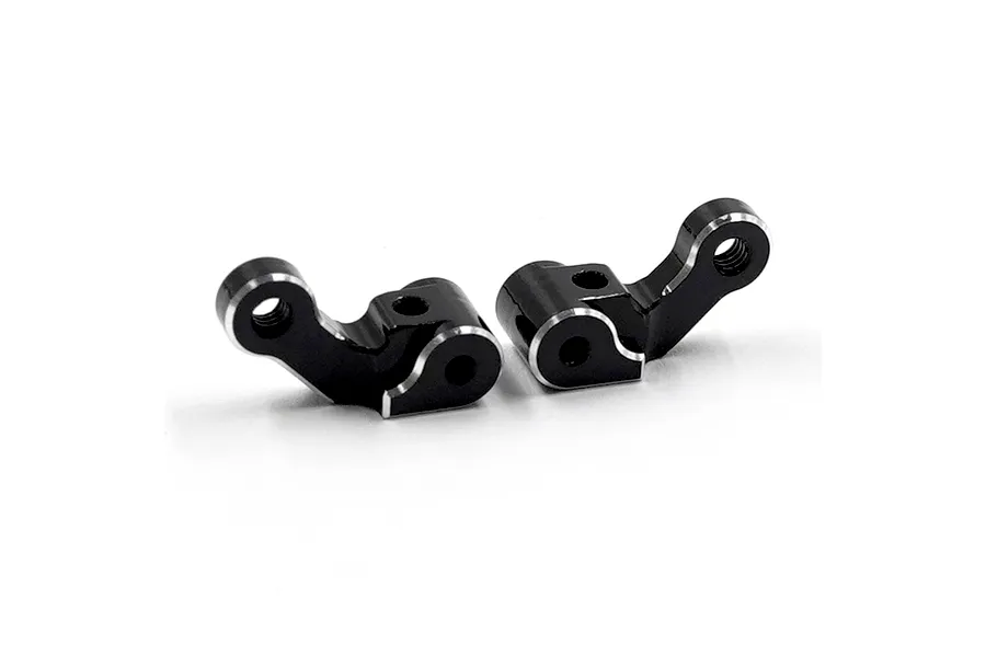 Two black aluminium RC front steering hubs with silver chamfered edges, positioned side-by-side on a white background.