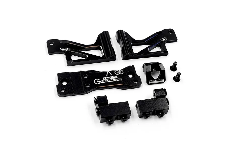 A set of black anodized aluminium RC car parts including servo mounts, chassis braces, and small screws on a white background.
