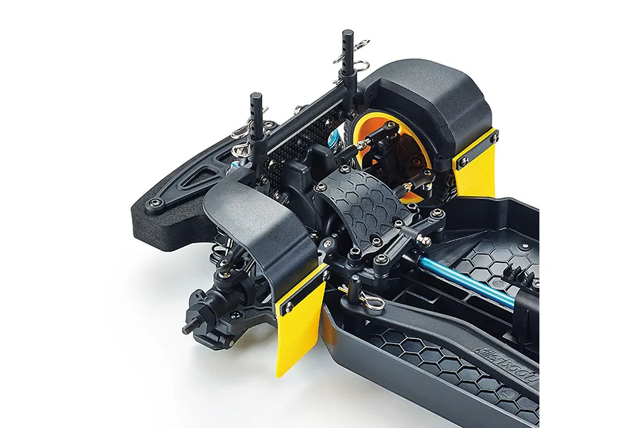 Close-up of the front chassis assembly of a Killerbody Mars KR10 RC rally car, showing suspension, mud flaps, and honeycomb-patterned plastic frame.