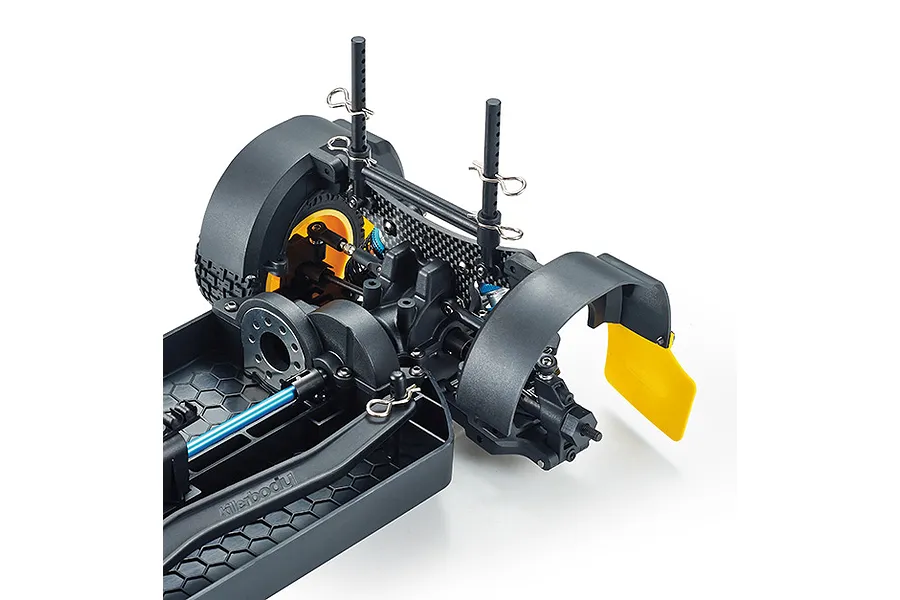 Close-up of the rear chassis assembly of a Killerbody Mars KR10 RC car, showing the suspension, mud flaps, and carbon fiber shock tower.