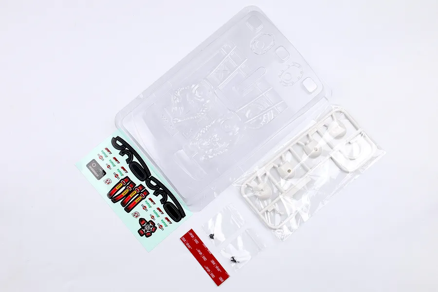 Killerbody Lancia Stratos Gr.4 unpainted cockpit set including clear polycarbonate parts, white plastic driver heads, decal sheet, and mounting hardware.