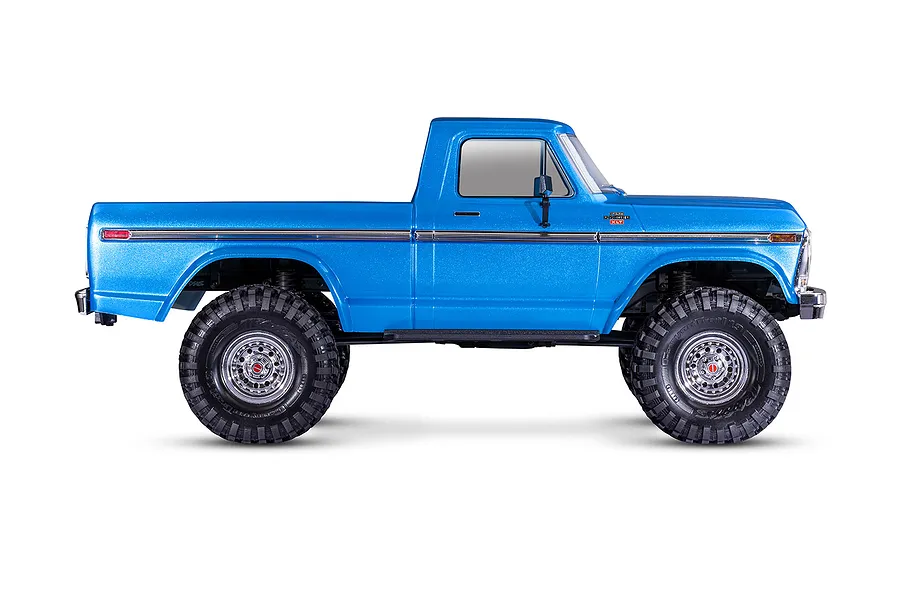 Side profile view of a bright blue Traxxas TRX-4 1979 Ford F-150 Ranger XLT RC rock crawler on a white background.