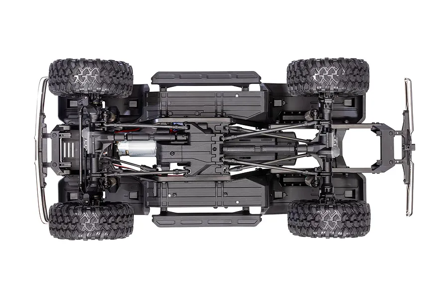 Top-down view of the Traxxas TRX-4 chassis showing the drivetrain, suspension, motor, and tires on a white background.