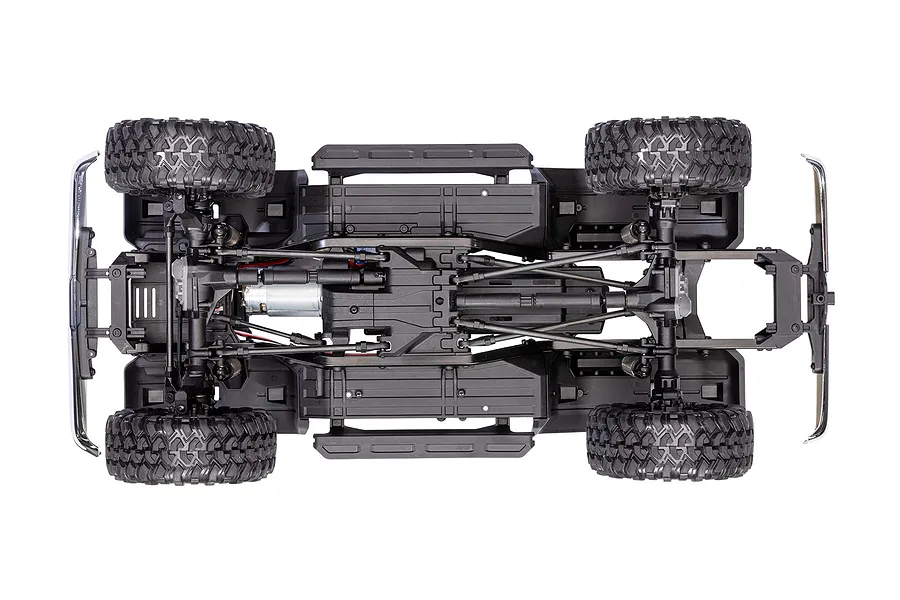 Top-down view of the Traxxas TRX-4 chassis showing the drivetrain, suspension, motor, and tires on a white background.