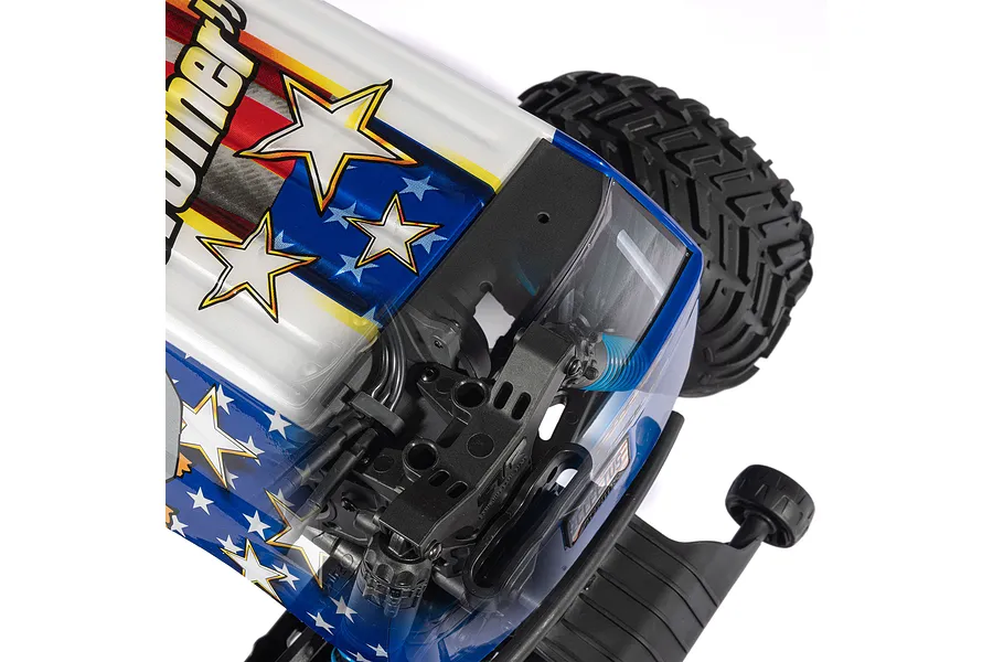 Close-up of an ARRMA RC monster truck body with a patriotic American flag design featuring stars and stripes, showing the chassis underneath.