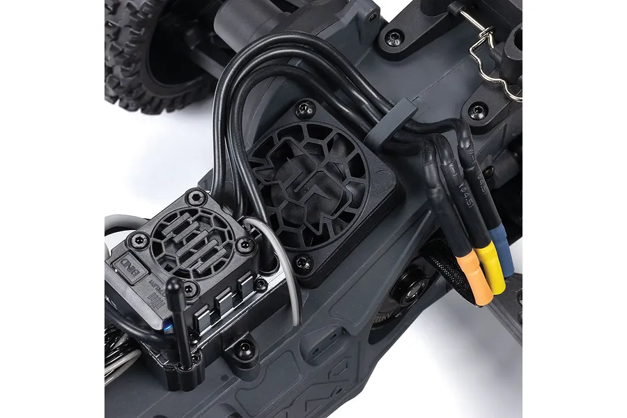 Close-up of the internal electronics and cooling fan mounted on the chassis of an ARRMA RC vehicle.