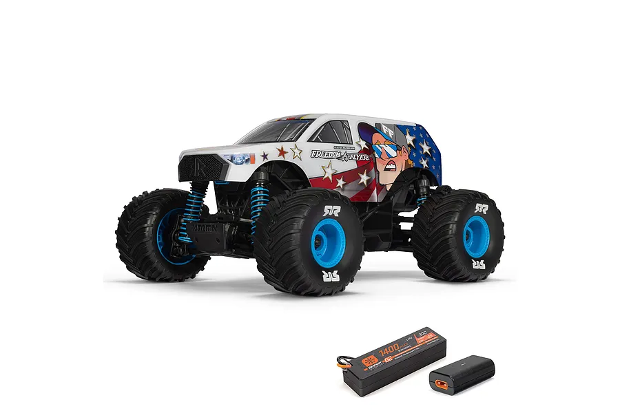 ARRMA Freedom Flyer Grom 1/16 scale RC monster truck with patriotic livery, shown with included Spektrum Smart G2 battery and charger.