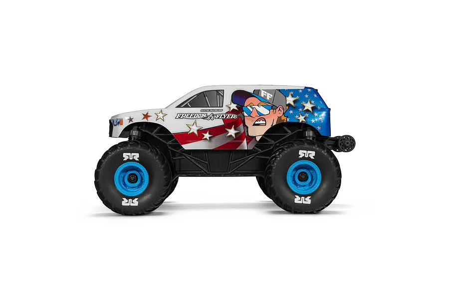Side profile of the ARRMA Freedom Flyer Grom RC monster truck with patriotic American flag livery and Cleutus McFarland character graphic.