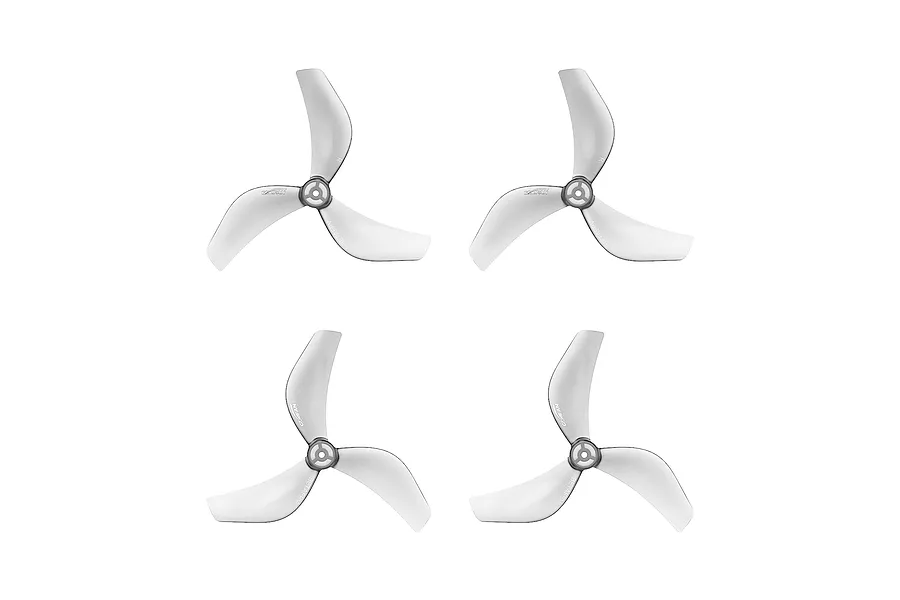 Four clear grey three-blade propellers for FPV drones, arranged in a grid on a white background.