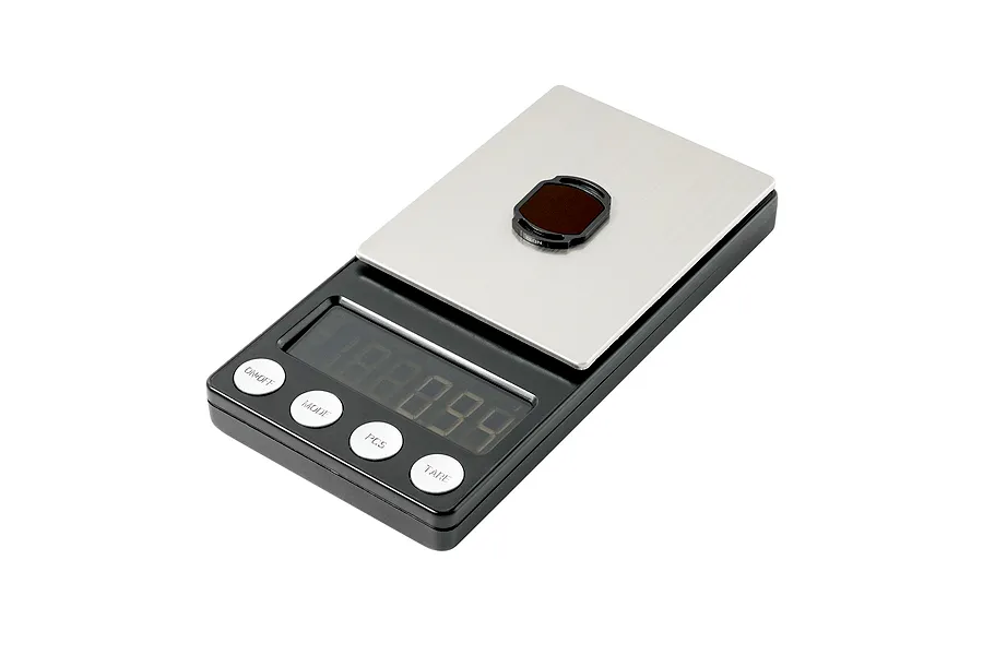 A small BetaFPV ND32 camera filter resting on a digital weighing scale to show its weight.