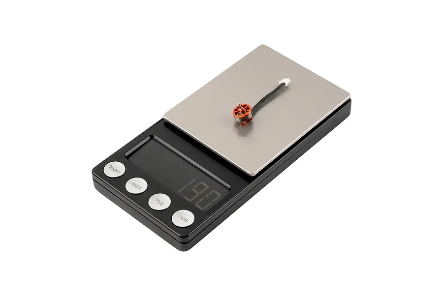 A single orange BetaFPV brushless motor sitting on a digital scale displaying a weight of 1.90 grams.