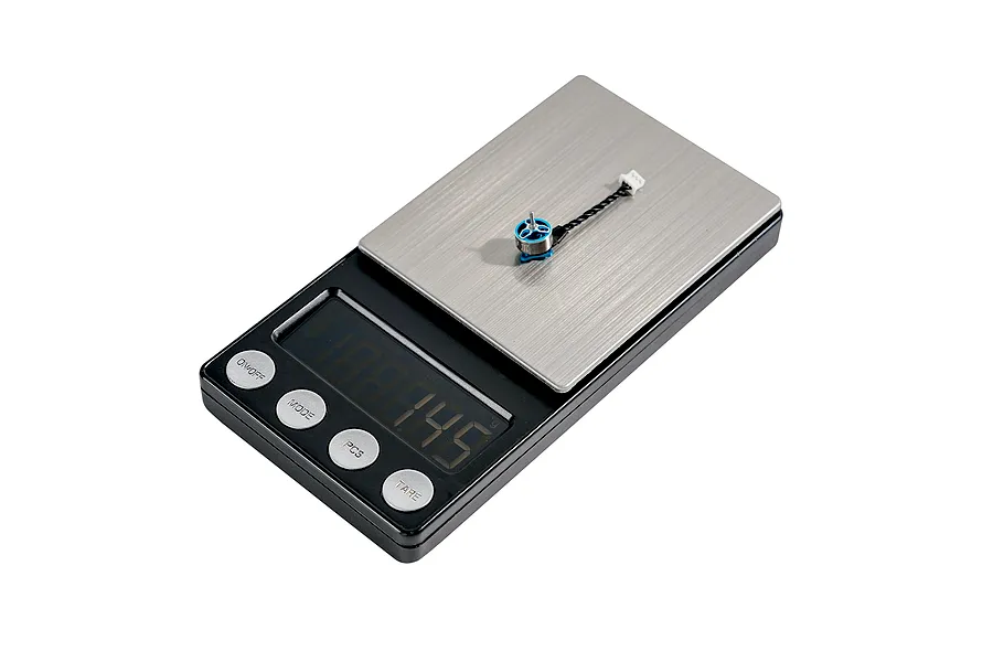 A single BetaFPV 0702SE II brushless motor placed on a digital scale to show its weight.