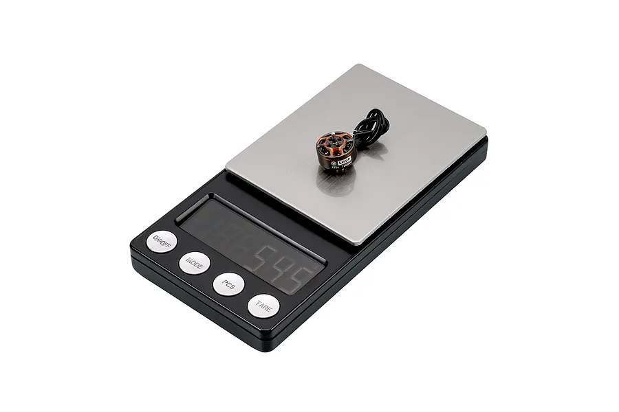 A BetaFPV Lava 1104 7200KV brushless motor sitting on a digital scale to show its weight.
