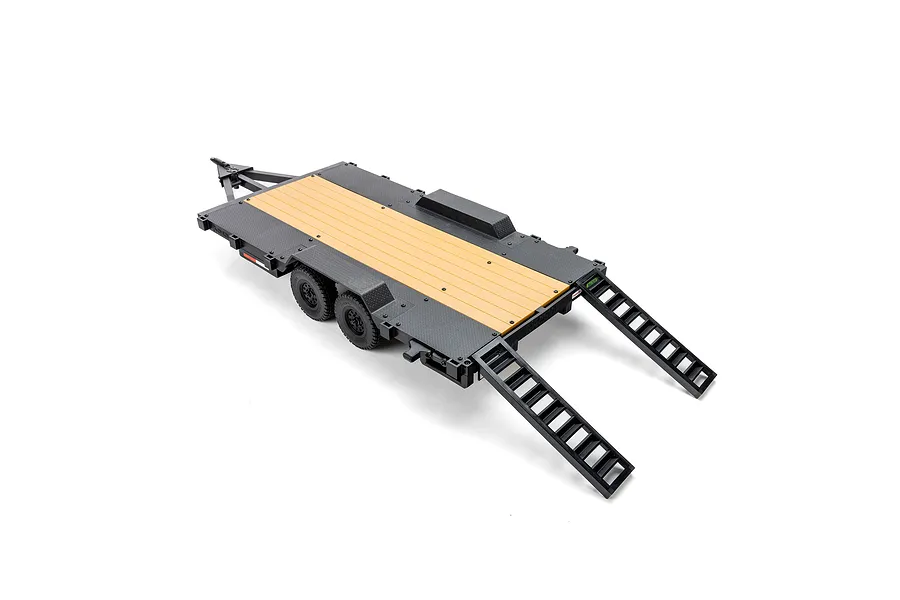 Axial 1/10 scale flat bed vehicle trailer with black frame and yellow wooden-look deck, featuring dual axles and rear loading ramps.