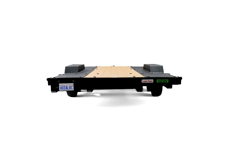 Rear view of an Axial 1/10 scale flat bed vehicle trailer with a wooden-look deck, black diamond plate fenders, and a custom California license plate.